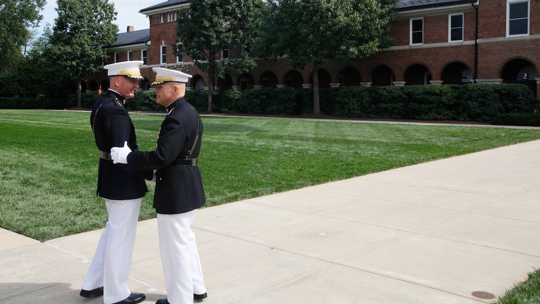 Gen. Robert B. Neller, right, and Joseph F. Dunford, Jr., shake hands following their passage of command ceremony at Marine Corps Barracks Washington, D.C., Sept. 24, 2015. Gen. Dunford, 36th and former Commandant of the Marine Corps, relinquished the position to Gen. Robert B. Neller, the 37th and new Commandant of the Marine Corps.