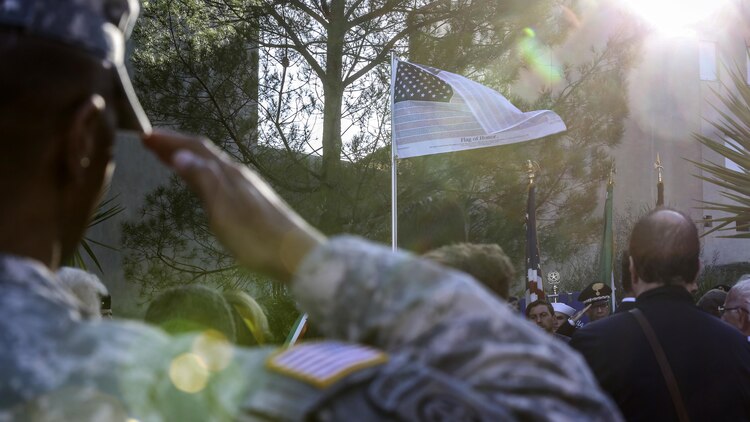 A U.S. Army soldier salutes as the ‘flag of honor’ is raised during a September 11th remembrance ceremony in Nissoria, Italy, Sept. 22, 2015. Marines and sailors with Special-Purpose Marine Air-Ground Task Force Crisis Response-Africa and other military members out of Naval Air Station Sigonella, Sicily, participated in the ceremony honoring the lives all the Americans and two Nissorian citizens lost that day. 