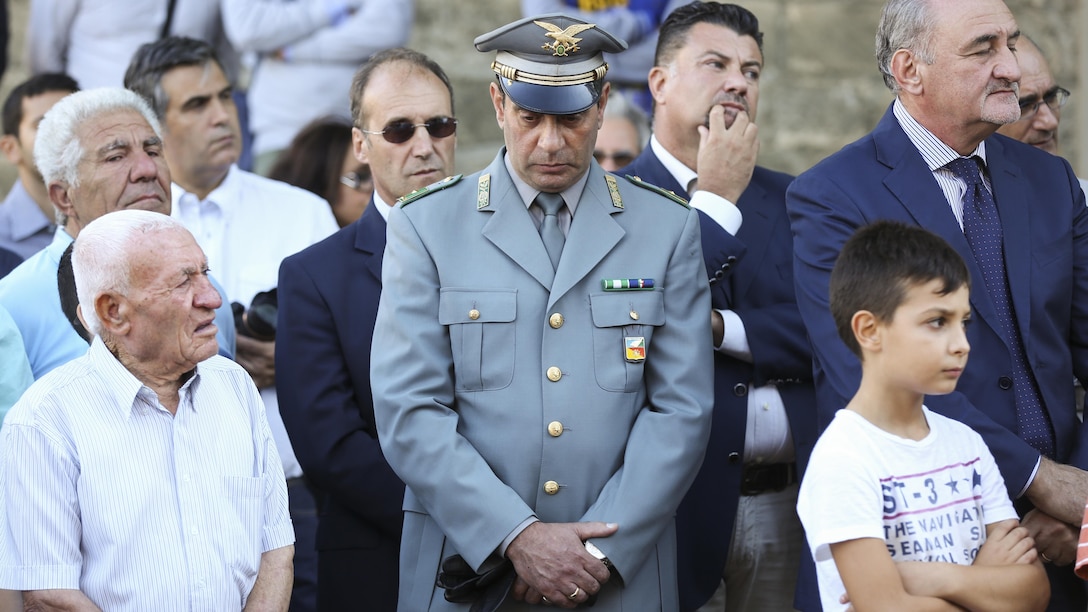 Nissorians listen to their mayor speak during a September 11th remembrance ceremony in Nissoria, Italy, Sept. 22, 2015. Marines and sailors with Special-Purpose Marine Air-Ground Task Force Crisis Response-Africa were asked to participate in the ceremony Nissoria holds yearly in remembrance of two Nissoria natives that lost their lives in the twin towers that day. 