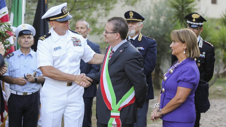 U.S. Navy Lt. Scott Jackson shakes the hand of Armando Glorioso, mayor of Nissoria, during a September 11th remembrance ceremony in Nissoria, Italy, Sept. 22, 2015. Marines and sailors with Special-Purpose Marine Air-Ground Task Force Crisis Response-Africa and other military members out of Naval Air Station Sigonella, Sicily, were invited by the mayor to participate in their annual ceremony to remember the global impact of the events on 9/11. 