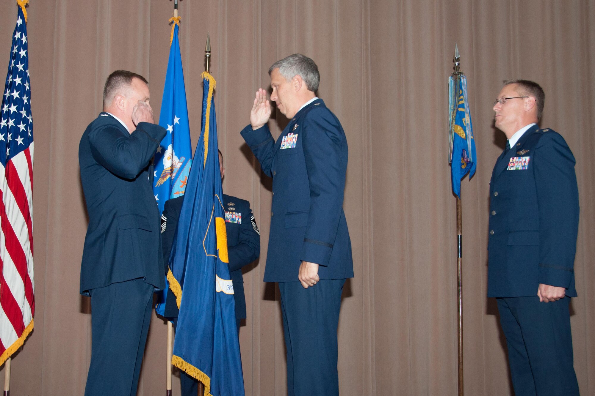 U.S. Air Force Lt. Col. Robert Burgess, 307th Operations Group commander, salutes Col. Bruce Cox, 307th Bomb Wing commander, during a ceremony at Barksdale Air Force Base, La., September 23, 2015. Looking on is Lt. Col. Joseph Hagans, 343rd Bomb Squadron commander, who assumed command of that unit from Burgess earlier in the ceremony.  (U.S. Air Force photo by Tech. Sgt. Ted Daigle/released)