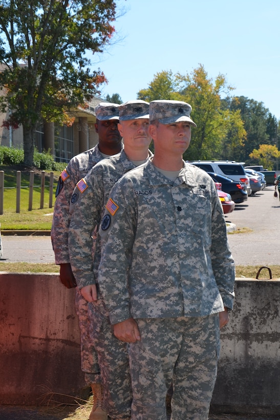 (front to back) Lt. Col. Timothy Rados, incoming commander for the 3rd Logistical Civil Augmentation Program Support Battalion, Col. Thomas Niles, commander of the LOGCAP Support Brigade, and Lt. Col. Lance Austin, outgoing commander of the 3rd LOGCAP Support Battalion prepare to enter as the official party of the change of command ceremony.