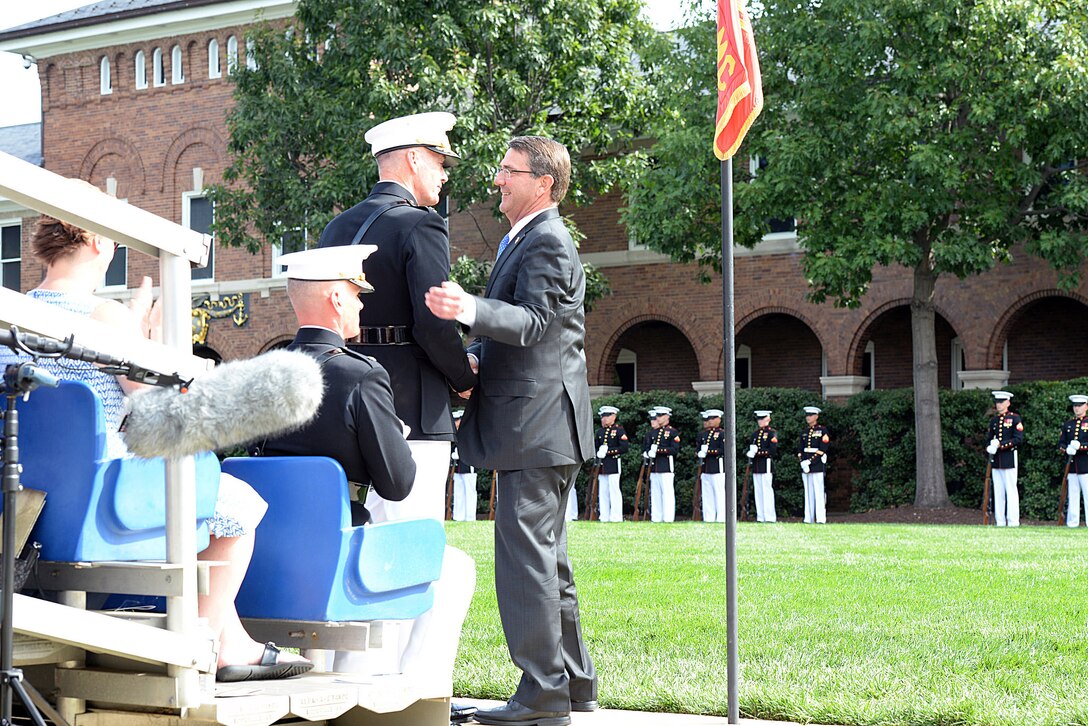 Defense Secretary Ash Carter shakes hands with Marine Corps Gen. Joseph F. Dunford Jr., outgoing commandant, during the Marine Corps passage-of-command ceremony on Marine Barracks Washington, D.C., Sept. 24, 2015. DoD photo by U.S. Army Sgt. 1st Class Clydell Kinchen