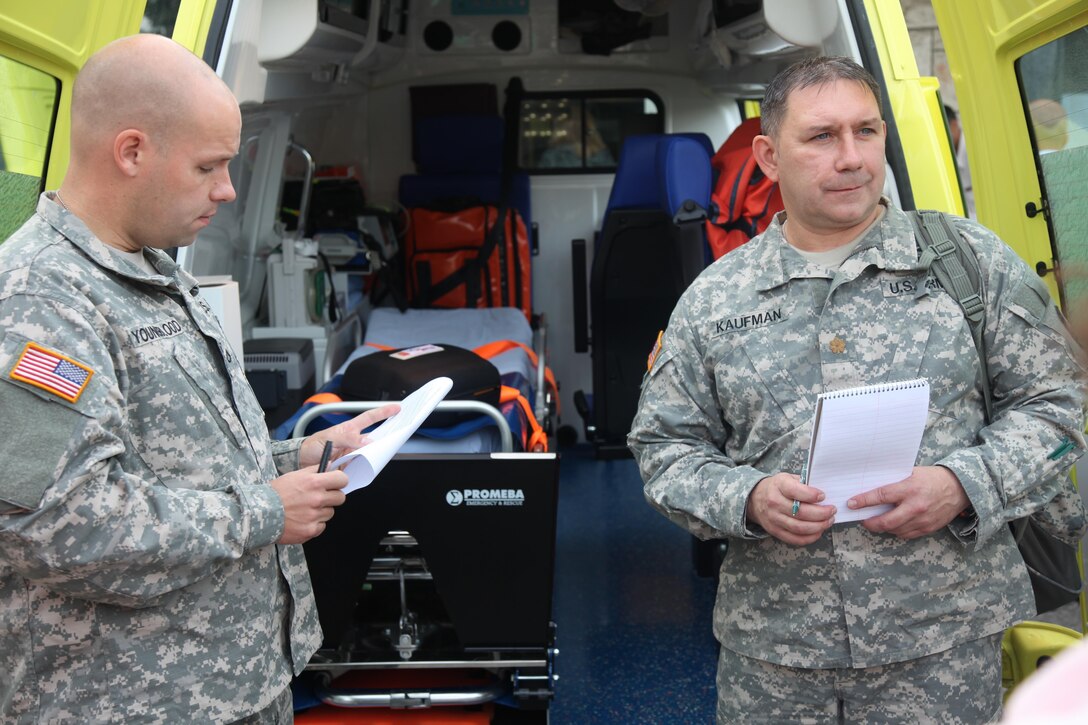 Left, Army Pfc. Carl Youngblood, a civil affairs specialist and Army Maj. Kevin Kaufman, chief of the civil affairs planning team, both from the 457th Civil Affairs Battalion, 7th Civil Support Command, speak with a U.S. Embassy-Croatia liaison/Humanitarian Assistance project coordinator and Croatian medical personnel while assessing European Command’s HA funded defibrillators and medical equipment, Sept. 11, 2015 in Split, Croatia.