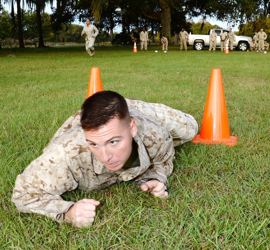 Cpl. Jacob Jones, distribution management clerk, Distribution Management Office, Marine Corps Logistics Base Albany, low crawls during the maneuver-under-fire portion of the Marine Corps Combat Fitness Test, here, Sept. 22.