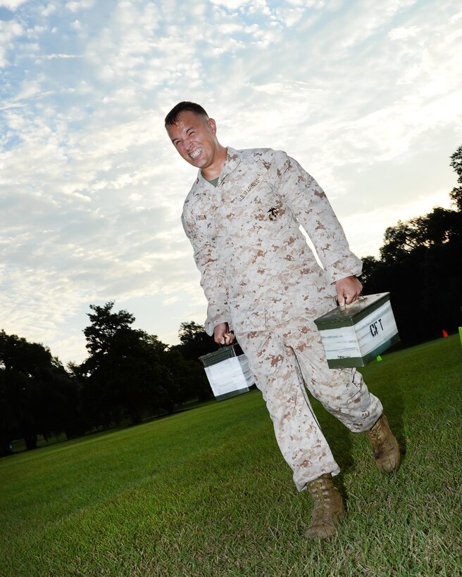 Sgt. Joshua Loflin, career planner, Marine Corps Logistics Base Albany, carries two 30-pound ammunition cans as he navigates the maneuver-under-fire portion of the Marine Corps Combat Fitness Test, here, Sept. 22.