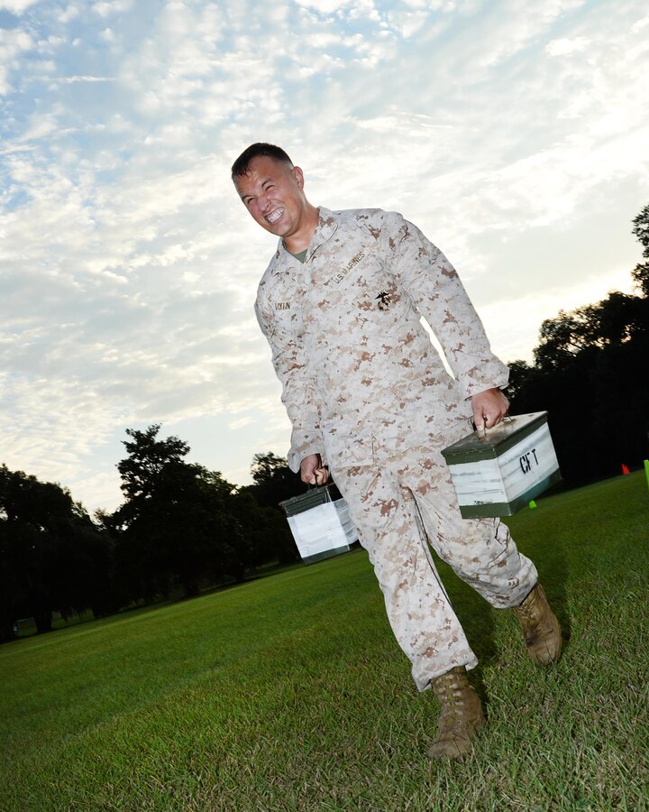 Sgt. Joshua Loflin, career planner, Marine Corps Logistics Base Albany, carries two 30-pound ammunition cans as he navigates the maneuver-under-fire portion of the Marine Corps Combat Fitness Test, here, Sept. 22.