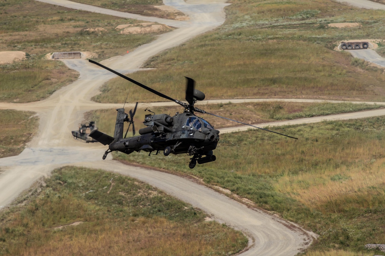 CAMP HUMPHREYS, South Korea (Sept. 21, 2015) - An AH-64 Apache augmented to the 2nd Battalion, 2nd Aviation Regiment, 2nd Combat Aviation Brigade provides attack support to ground forces at the Rodriguez Live Fire Complex in South Korea.  