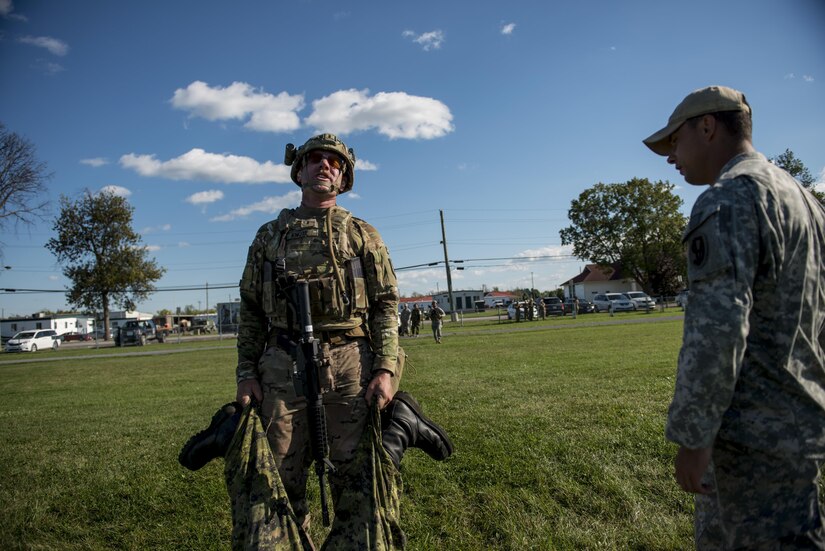 Chief Warrant Officer Two Andy Knote, of North Chicago, U.S. Army Reserve International Combat Team competitor, strains while carrying a 75-kilogram dummy across a 100-meter distance during a 7-kilometer Rifle Military Biathlon match involving several physical obstacles during the 2015 Canadian Armed Forces Small Arms Concentration at the Connaught Range outside of Ottawa, Canada, Sept. 14. The international marksmanship competition lasted roughly two weeks, bringing in more than 250 total competitors from the British, Canadian and U.S. armed forces competing in more than 50 matches involving rifle, pistol and light machine gun events using various combat-like movements and scenarios. (U.S. Army photo by Master Sgt. Michel Sauret)