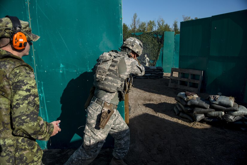 Staff Sgt. Chris Kizanis, of Boise State, Idaho, U.S. Army Reserve International Combat Team shooter, engages enemy targets during a Dynamic Pistol Range as part of the 2015 Canadian Armed Forces Small Arms Concentration at the Connaught Range outside of Ottawa, Canada, Sept. 16. The international marksmanship competition lasted roughly two weeks, bringing in more than 250 total competitors from the British, Canadian and U.S. armed forces competing in more than 30 matches involving rifle, pistol and light machine gun events using various combat-like movements and scenarios. (U.S. Army photo by Master Sgt. Michel Sauret)