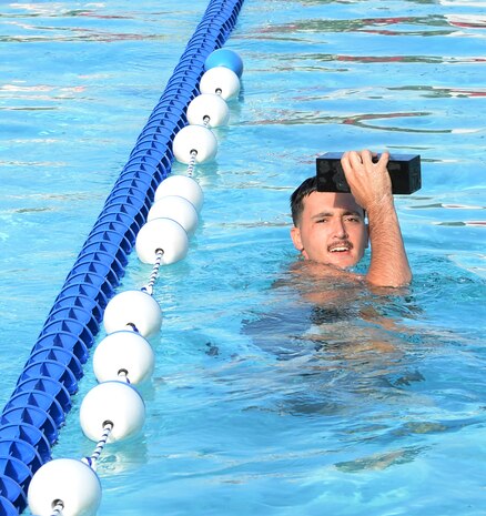 Lance Cpl. George Bagley, radio repairman, Detachment 4, Combat Logistics Battalion-451, swims with a brick during the screening test for Marine Corps Instructor of Water Survival school during his annual training aboard Marine Corps Logistics Base Albany, Sept. 22.