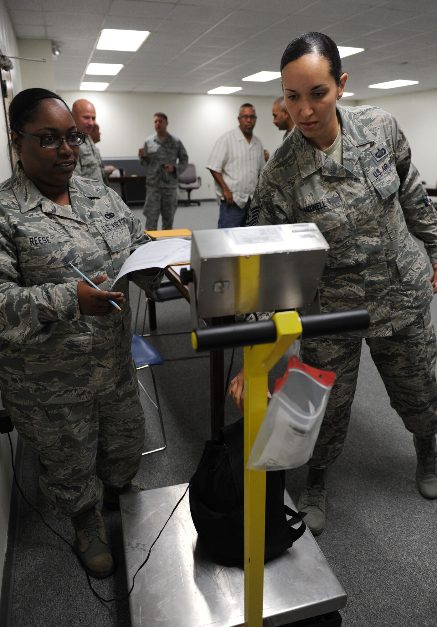 Tech. Sgt. Tomekia Reese, 81st Logistics Readiness Squadron personal property processing office NCO in charge, logs the luggage weight of Tech. Sgt. Jasmine Howell, 81st Force Support Squadron career development NCO in charge, as she processes through the deployment line during a deployment exercise at the Taylor Logistics Center Sept. 24, 2015,  Keesler Air Force Base, Miss. The exercise scenario tested the mission readiness of Team Keesler members for world-wide deployments. (U.S. Air Force photo by Kemberly Groue)