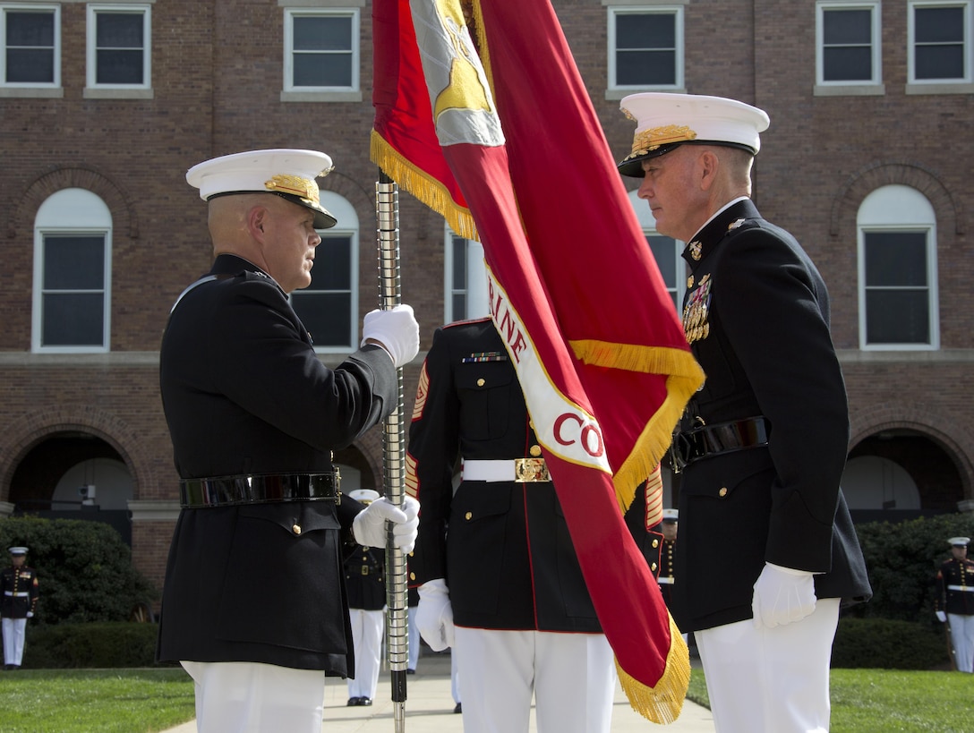 Marine Corps Gen. Robert B. Neller, left, accepts the Marine Corps colors from Gen. Joseph F. Dunford Jr. during a ceremony at Marine Barracks Washington, D.C., Sept. 24, 2015. Neller took command from Dunford as commandant of the Marine Corps. U.S. Marine Corps photo by Sgt. Gabriela Garcia
