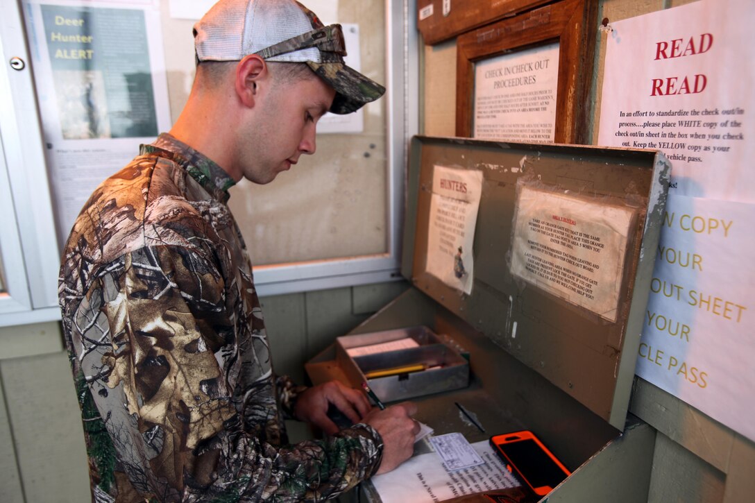 Cpl. Mitchell Teusch signs in at the game warden’s office during archery hunting season at Marine Corps Air Station Cherry Point, N.C., Sept. 22, 2015. To hunt on Marine Corps Air Station Cherry Point, participants must take a hunter’s safety education course for the state of North Carolina and buy a state hunting license. After the course, they must attend a hunter orientation class where the regulations and rules about hunting on base are explained. Upon completion, they are then allowed to buy a base permit. Teusch is a quality assurance hydraulic mechanic with Marine Aircraft Group 14. (U.S. Marine Corps photo by Lance Cpl. Jason Jimenez/Released)