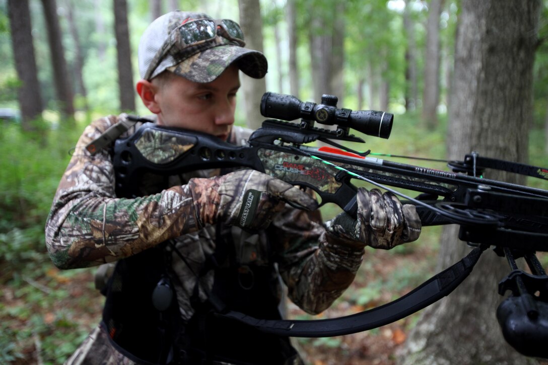 Cpl. Mitchell Teusch sights down his crossbow during archery hunting season at Marine Corps Air Station Cherry Point, N.C., Sept. 22, 2015. Hunters can use a variety of weapons from appropriate firearms to bow and arrows that meet state regulations. Hunting on Cherry Point is open to active duty personnel, their dependents, retirees, DOD employees and sponsored guests. Teusch is a quality assurance hydraulic mechanic with Marine Aircraft Group 14. (U.S. Marine Corps photo by Lance Cpl. Jason Jimenez/Released)
