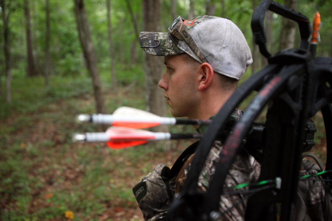 Cpl. Mitchell Teusch looks for a good place to set up his fall-restraint system during archery hunting season at Marine Corps Air Station Cherry Point, N.C., Sept. 22, 2015. A fall-restraint system catches you within a few feet to prevent hitting the ground when sitting on a tree stand. Hunting on Cherry Point is open to active duty personnel, their dependents, retirees, DOD employees and sponsored guests. Teusch is a quality assurance hydraulic mechanic with Marine Aircraft Group 14. (U.S. Marine Corps photo by Lance Cpl. Jason Jimenez/Released)