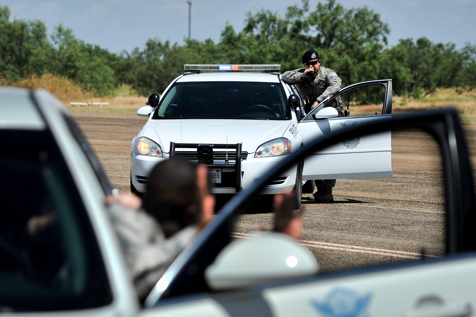 U.S. Air Force Senior Airman Eduardo J. Sanchez, 17th Security Forces Squadron patrolman, performs a high risk traffic stop during a flight level exercise on Goodfellow Air Force Base, Texas, Aug. 24, 2015. During the exercise, Sanchez and his wingmen apprehended the suspects and searched their vehicle. (U.S. Air Force photo by Airman 1st Class Devin Boyer/Released)