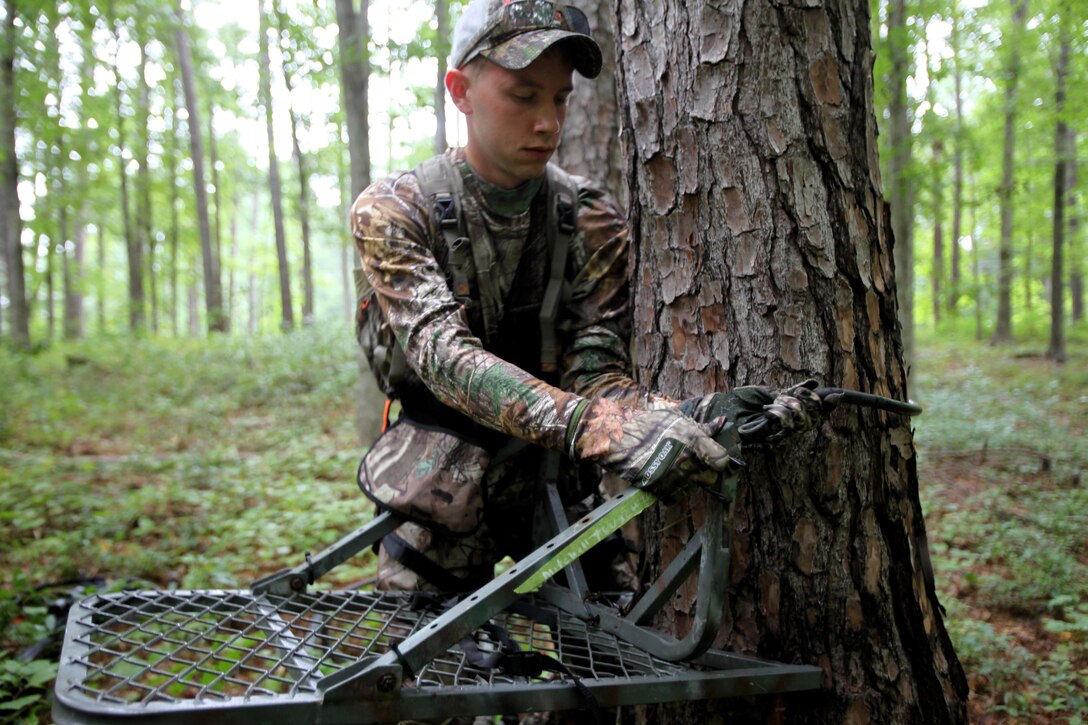 Cpl. Mitchell Teusch sets up his fall-restraint system during archery hunting season at Marine Corps Air Station Cherry Point, N.C., Sept. 22, 2015. A fall-restraint system protects the hunter from falling out of a tree stand. Hunting on Cherry Point is open to active duty personnel, their dependents, retirees, DOD employees and sponsored guests. Teusch is a quality assurance hydraulic mechanic with Marine Aircraft Group 14. (U.S. Marine Corps photo by Lance Cpl. Jason Jimenez/Released)