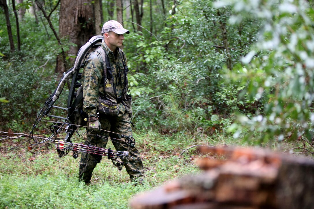 Gunnery Sgt. Jeffrey Short walks behind the tree line toward his hunting area with a crossbow during archery hunting season at Marine Corps Air Station Cherry Point, N.C., Sept. 22, 2015. Hunting on Cherry Point is open to active duty personnel, their dependents, retirees, DOD employees and sponsored guests. Short is the Air Combat Intelligence company gunnery sergeant for Marine Wing Headquarters Squadron 2. (U.S. Marine Corps photo by Lance Cpl. Jason Jimenez/Released)