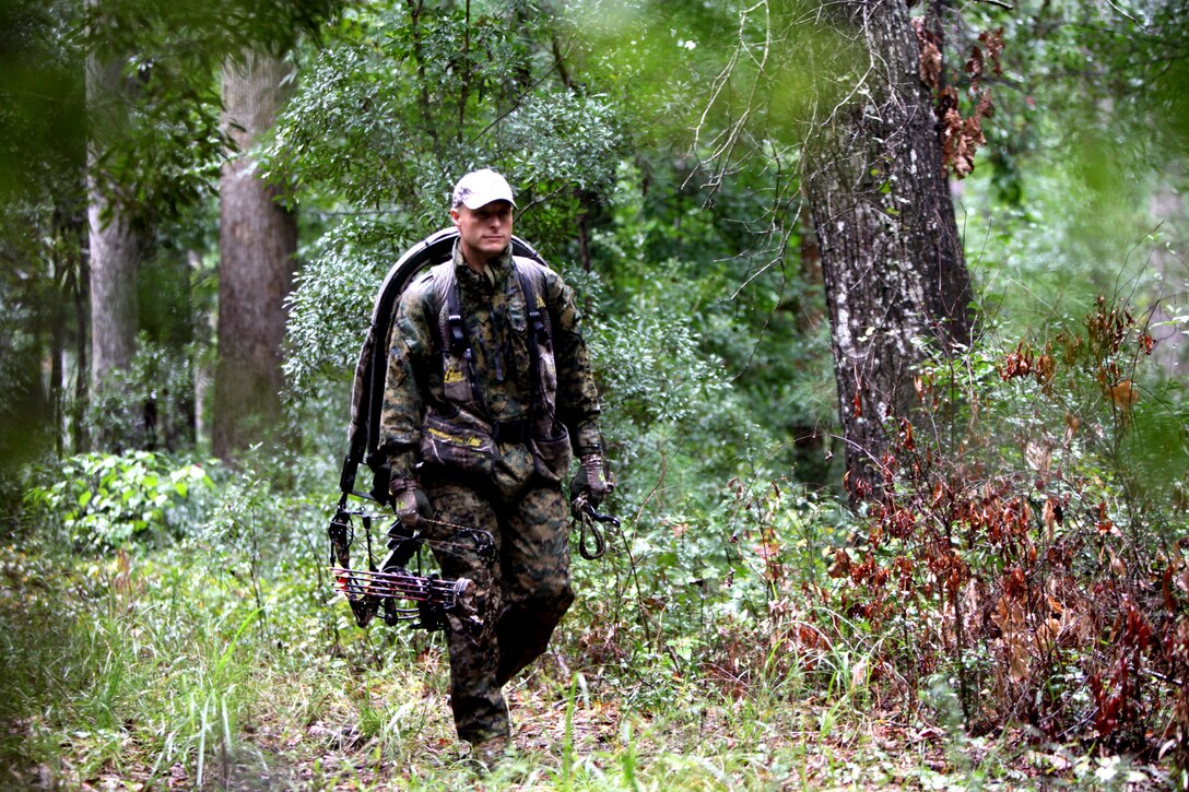 Gunnery Sgt. Jeffrey Short walks behind the tree line toward his hunting area with a crossbow during archery hunting season at Marine Corps Air Station Cherry Point, N.C., Sept. 22, 2015. Hunting on Cherry Point is open to active duty personnel, their dependents, retirees, DOD employees and sponsored guests. Short is the Air Combat Intelligence company gunnery sergeant for Marine Wing Headquarters Squadron 2. (U.S. Marine Corps photo by Lance Cpl. Jason Jimenez/Released)
