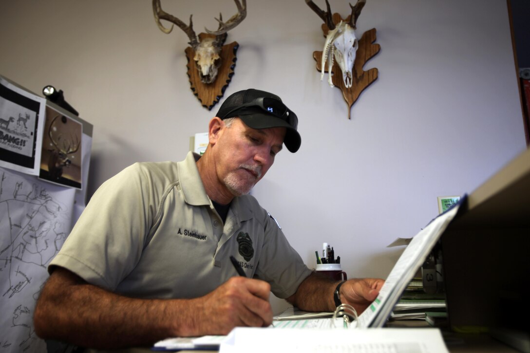 Officer Alan Steinhauer inputs harvest data during archery hunting season at Marine Corps Air Station Cherry Point, N.C., Sept. 22, 2015. Harvest is the count of wildlife hunted and recorded. Hunting on Cherry Point is open to active duty personnel, their dependents, retirees, DOD employees and sponsored guests. Steinhauer is a U.S. conservation law enforcement officer here. (U.S. Marine Corps photo by Lance Cpl. Jason Jimenez/Released)