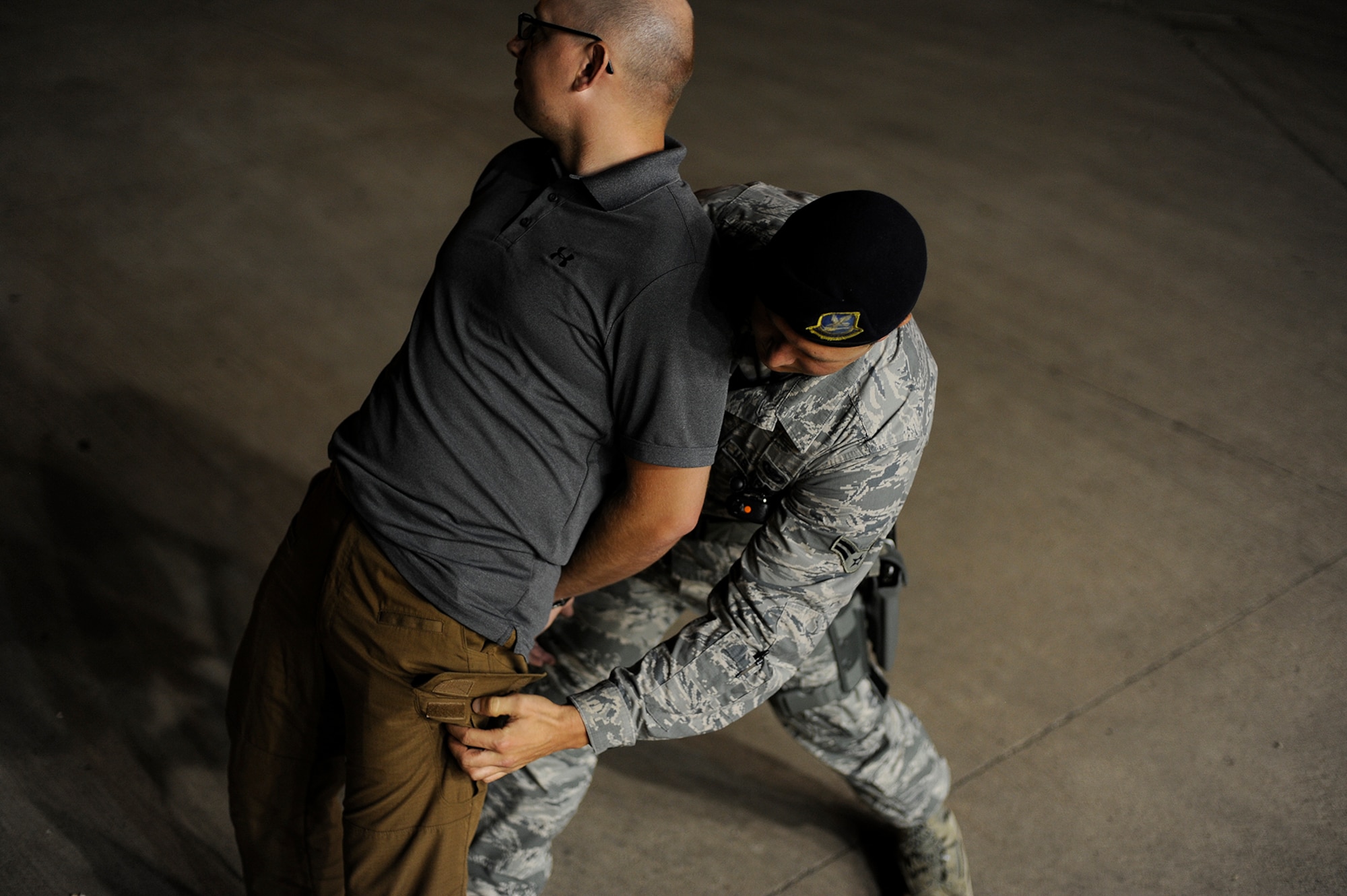 U.S. Air Force Airman 1st Class Forest A. Davis, 17th Security Forces Squadron entry controller, performs a search on an individual during an apprehension exercise on Goodfellow Air Force Base, Texas, Aug. 27, 2015. Before apprehending the individual, Davis and his wingmen performed a sobriety test to see if the suspect was under the influence of alcohol. (U.S. Air Force photo by Airman 1st Class Devin Boyer/Released)