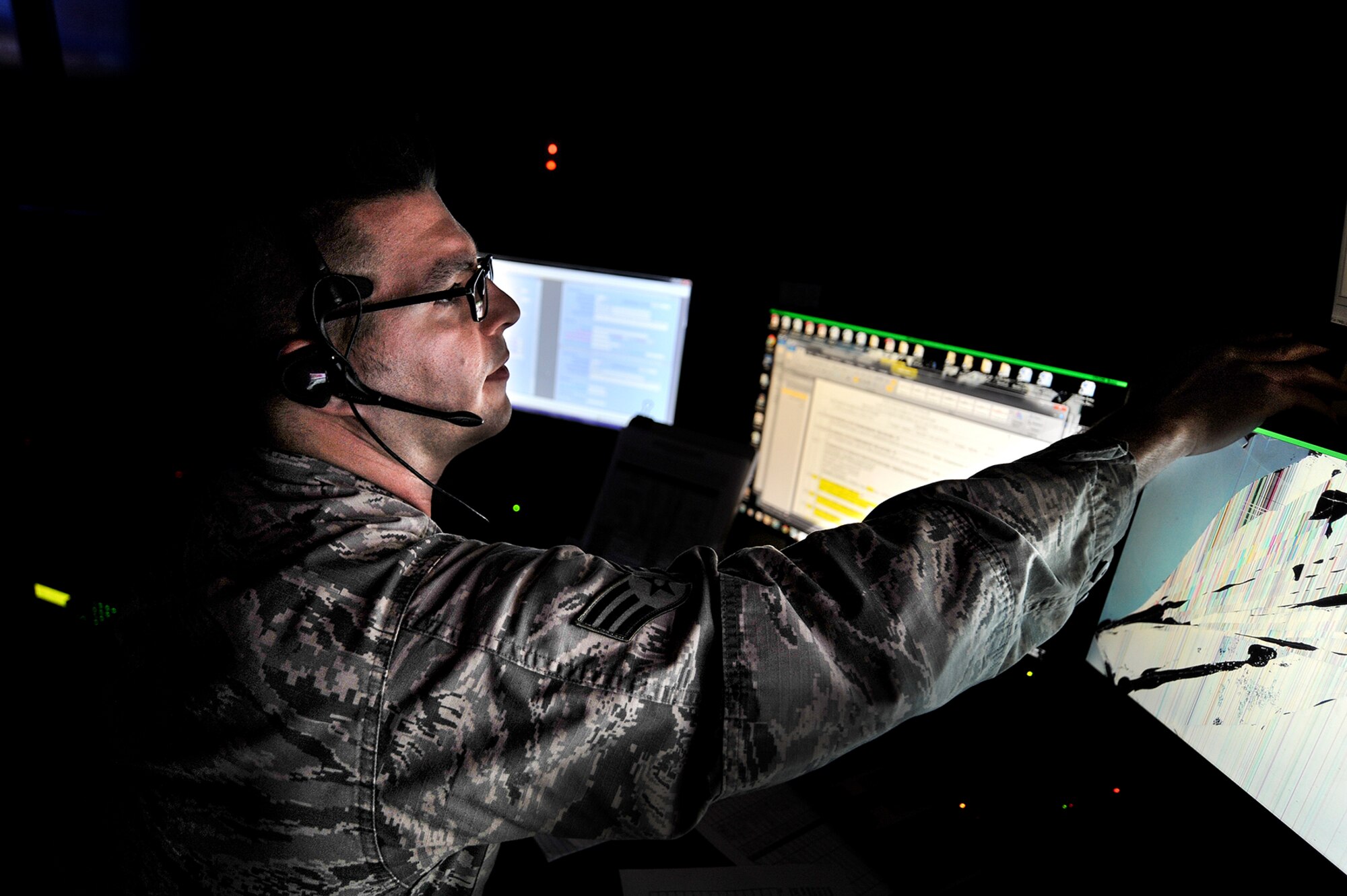 U.S. Air Force Senior Airman Garrett K. Kozel, 17th Security Forces Squadron law enforcement desk operator, manages the Security Forces Control Center on Goodfellow Air Force Base, Texas, Aug. 24, 2015. The SFCC is the central point for all law enforcement activities on base. (U.S. Air Force photo by Airman 1st Class Devin Boyer/Released)