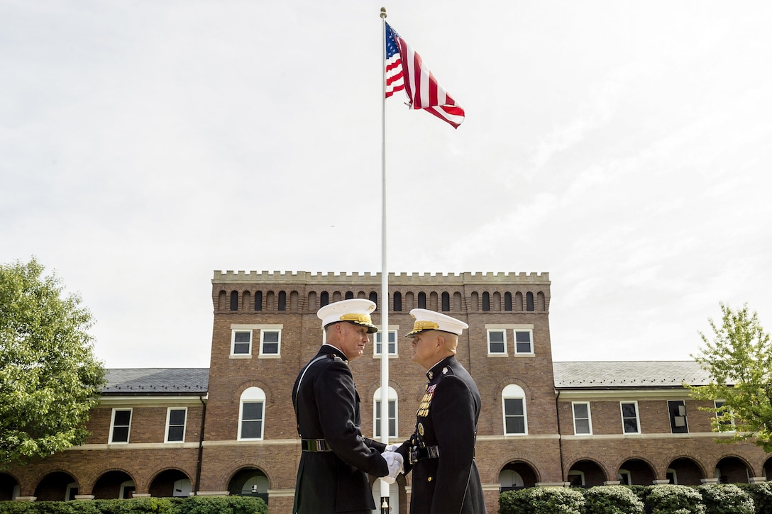 Outgoing Commandant Marine Corps Gen. Joseph F. Dunford Jr., left, and Marine Corps Gen. Robert B. Neller shake hands during the passage-of-command ceremony on Marine Barracks Washington, D.C., Sept. 24, 2015. Dunford relinquished command to Neller. Dunford will assume duties as the chairman of the Joint Chiefs of Staff. DoD photo by U.S. Army Staff Sgt. Sean K. Harp







