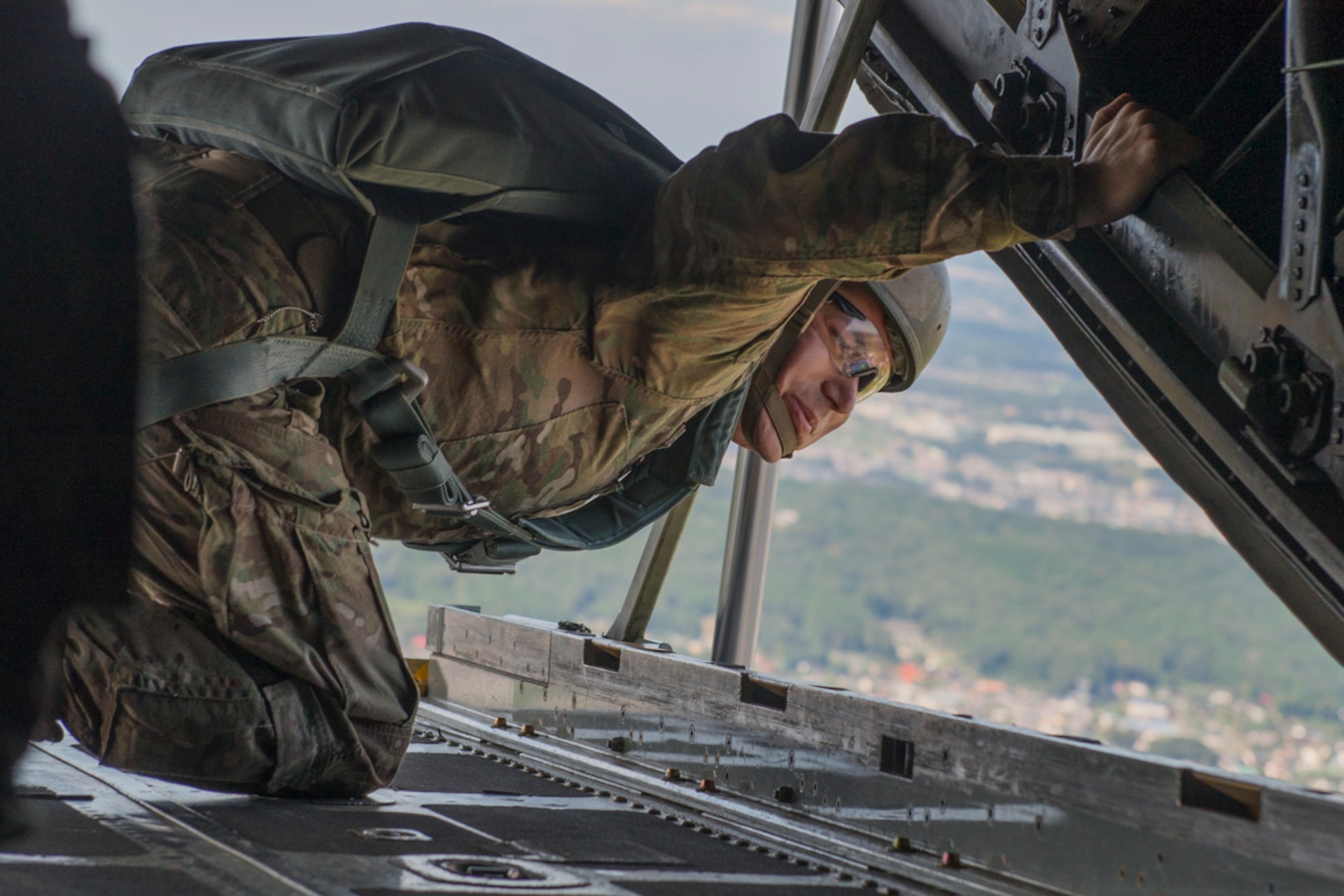 US Army Staff Sgt. Brian Wright, 1st Battalion, 1st Special Operations Group (Airborne), checks the outside of a C-130 Hercules for possible safety hazards during the 2015 Japanese-American Friendship Festival at Yokota Air Base, Japan, Sept. 20, 2015. Wright was the safety controller during an airdrop demonstration at the festival. (U.S. Air Force photo by Staff Sgt. Cody H. Ramirez/Released) 