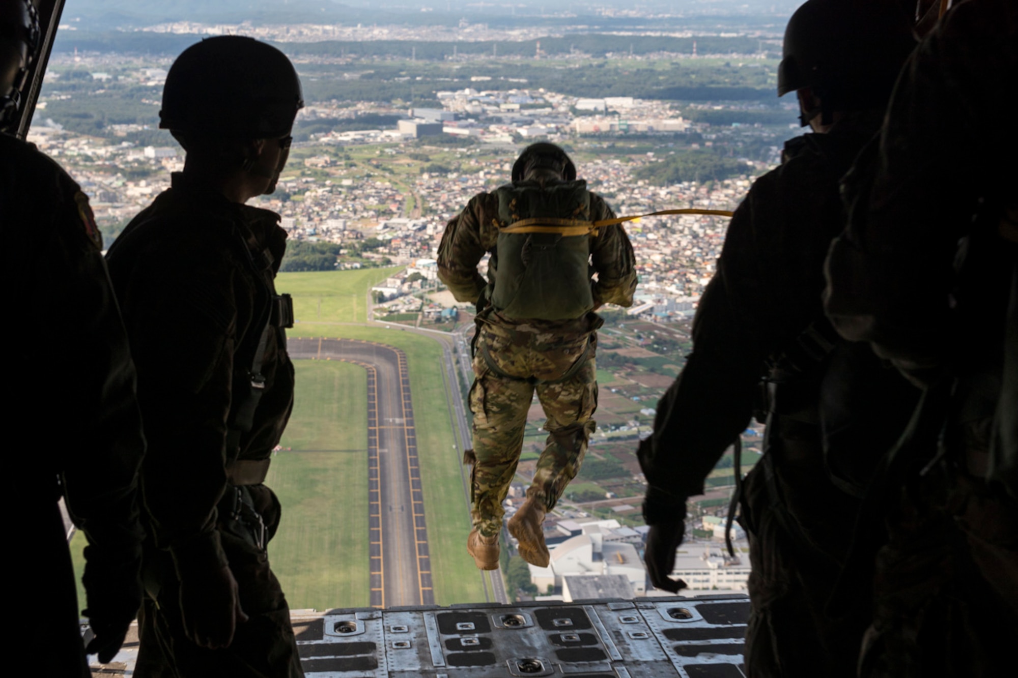A Soldier with the 1st Battalion, 1st Special Operations Group (Airborne), jumps from a C-130 Hercules during the 2015 Japanese-American Friendship Festival at Yokota Air Base, Japan, Sept. 20, 2015. The jumpers showcased Yokota's airdrop capability to a crowd of tens of thousands; more than 185,000 people attended the two-day festival. (U.S. Air Force photo by Staff Sgt. Cody H. Ramirez/Released)
