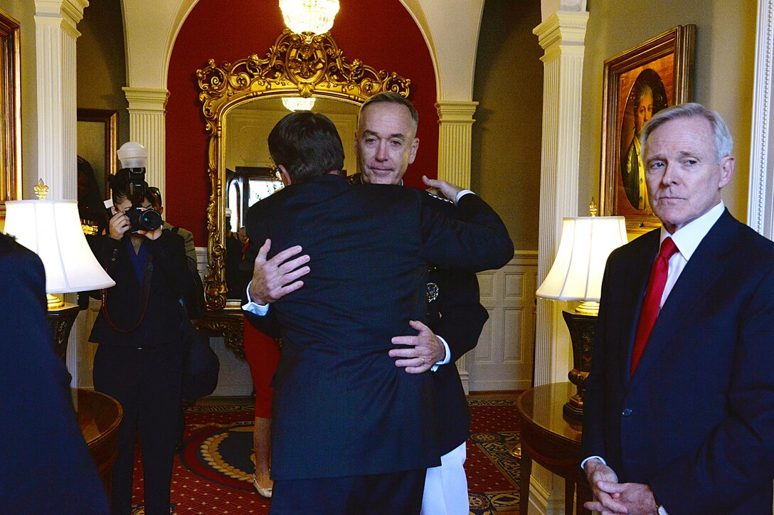 Defense Secretary Ash Carter shares an embrace with outgoing commandant Marine General Joseph F. Dunford Jr before the Marine Corps commandant passage of command ceremony at the Marine Barracks Washington, Sept. 24, 2015. DoD photo by U.S. Army Sgt. 1st Class Clydell Kinchen