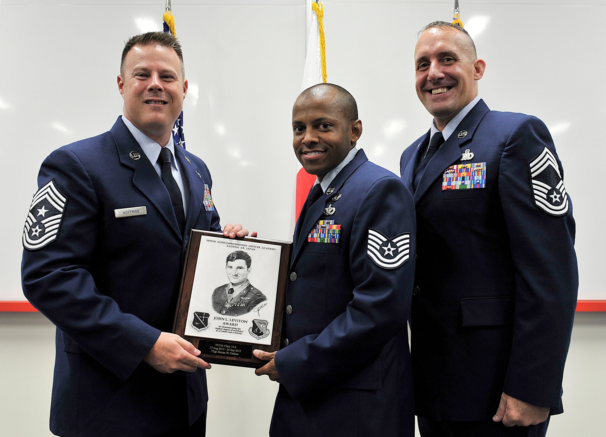 U.S. Air Force Tech. Sgt. Sheraz Cedeno, 374th Civil Engineer Squadron NCO in charge of emergency management planning and operations at Yokota Air Base, Japan, receives the John L. Levitow Award during the NCO Academy Class 15-6 graduation ceremony Sept. 24, 2015, on Kadena Air Base, Japan. This award, named in memory of Medal of Honor recipient Airman 1st Class John L. Levitow, is presented to the most outstanding member of professional military education classes and denotes superior achievement as both a leader and a scholar. (U.S. Air Force photo by Naoto Anazawa)