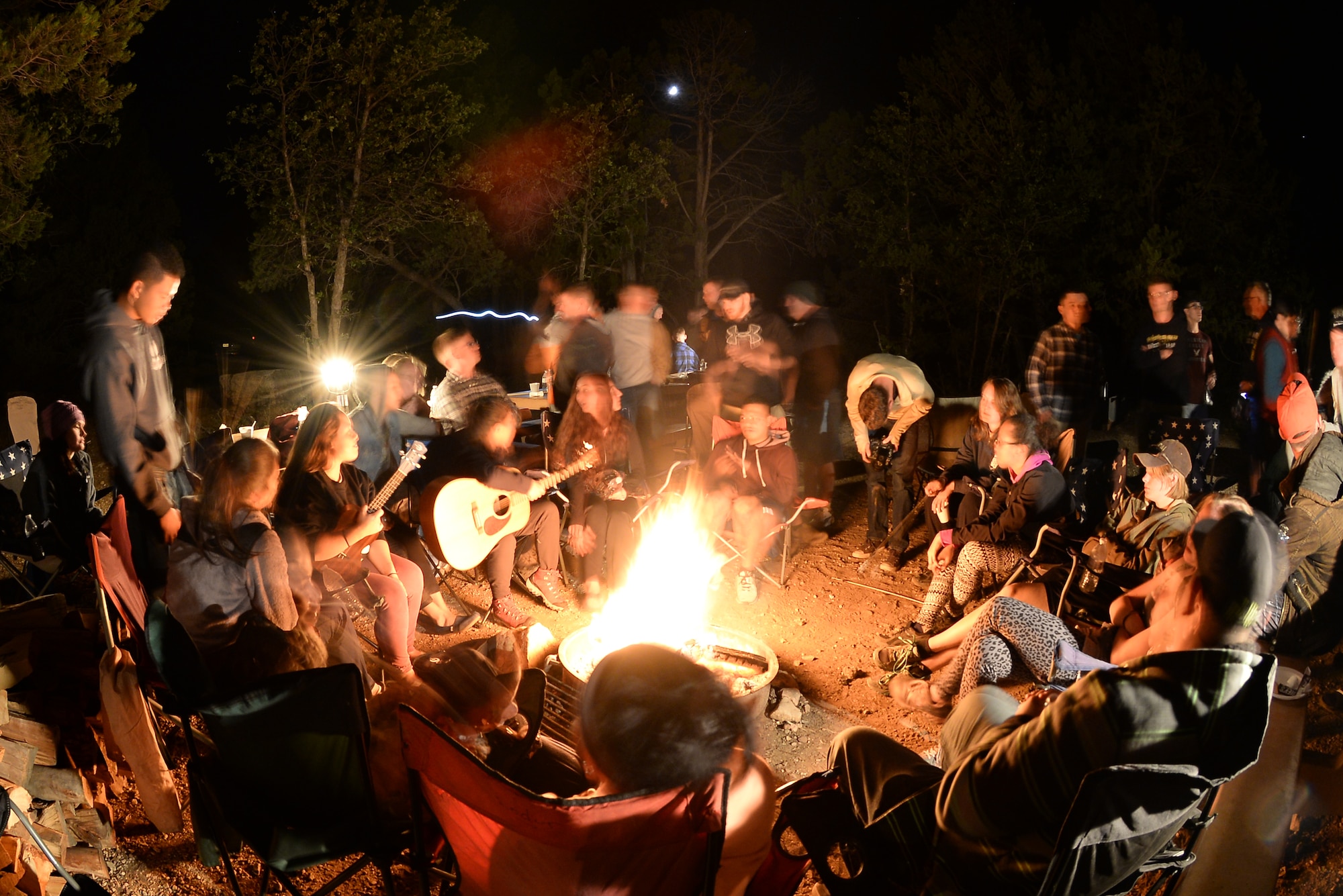 U.S. service members sit around a campfire playing instruments, roasting marshmallows and drinking hot chocolate at Mather Camp Ground along the South Rim of Grand Canyon National Park Sept. 19, 2015. The service members were at the canyon as part of the 2015 Grand Canyon Breakaway Weekend. (U.S. Air Force photo by Airman 1st Class Ashley N. Steffen/Released)