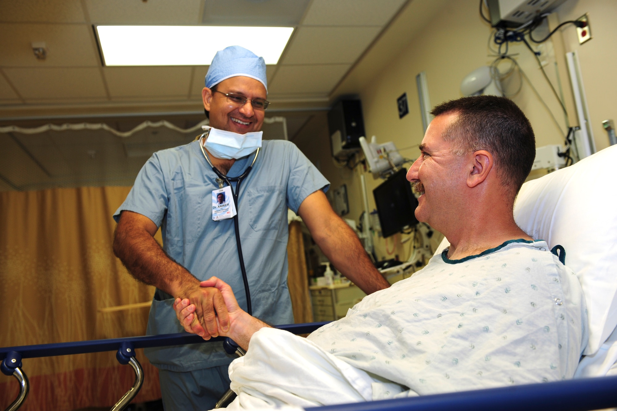 U.S. Air Force Tech. Sgt. Bruce Davis, 527th Space Aggressor Squadron radio frequency transmission supervisor, shakes hands with Dr. Faiz Anwer, medical oncologist, at Banner-University Medical Center in Tucson, Ariz., July 2015. Anwer was the lead doctor during Davis’ bone marrow collection procedure, which was facilitated by the C.W. Bill Young Department of Defense Marrow Donor Program. (U.S. Air Force photo by Airman 1st Class Chris Drzazgowski/Released) 