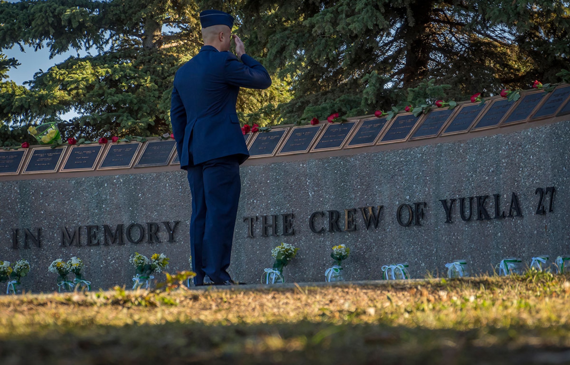 An Airman salutes after placing flowers during a ceremony as American, and Canadian Airmen assigned to the 962nd Airborne Air Control Squadron, distinguished guests, and surviving family members of the crew of the E-3B Sentry, Airborne Warning and Control System aircraft, call sign "YUKLA 27" gathered for 20th anniversary memorial ceremonies on Joint Base Elmendorf-Richardson, Alaska, Tuesday, Sept. 22, 2015. On Elmendorf Air Force Base, Sept. 22, 1995, the “YUKLA 27" aircraft from the 962nd Airborne Air Control Squadron encountered a flock of geese and crashed shortly after takeoff on a routine surveillance training sortie, killing all 24 U.S. and Canadian Airmen aboard. (U.S. Air Force photo/Justin Connaher)