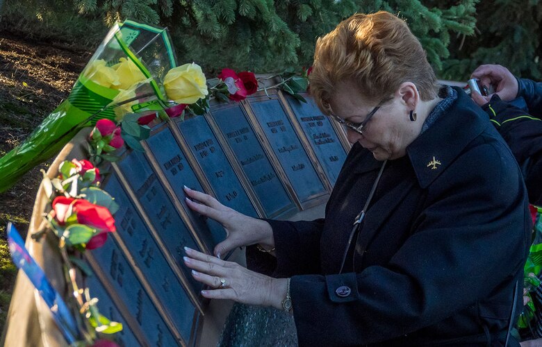 Linda DeFrancesco, mother of Senior Airman Lawrence DeFrancesco, places her hands on a plaque with her son’s name on it during a quiet moment before a ceremony at the Yukla 27 memorial. American and Canadian airmen assigned to the 962nd Airborne Air Control Squadron, distinguished guests, and surviving family members of the crew of the E-3B Sentry, Airborne Warning and Control System aircraft, call sign Yukla 27, gathered for 20th anniversary memorial ceremonies on Joint Base Elmendorf-Richardson, Tuesday. On Elmendorf Air Force Base, Sept. 22, 1995, Yukla 27 from the 962nd Airborne Air Control Squadron encountered a flock of geese and crashed shortly after takeoff on a routine surveillance training sortie, killing all 24 U.S. and Canadian Airmen aboard. (U.S. Air Force photos/Justin Connaher)