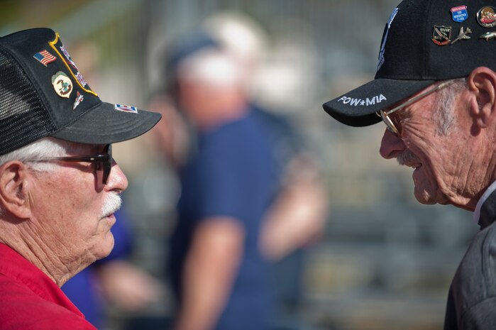 Don Harten, a retired B-52 Stratofortress/F-105 Thunderchief/F-111 Aardvark pilot, speaks to former prisoner of war and retired colonel Jim Padgett during the Prisoners of War/Missing in Action Recognition Ceremony at Nellis Air Force Base, Nev., Sept. 18, 2015. Padgett, a rear seat weapons systems operator of an F-105 during the Vietnam War, was a POW from May 11, 1972 to March 28, 1973, and comes to the Nellis AFB POW/MIA ceremony every year to pay his respects to his fallen brothers who never returned home from the jungles of Vietnam. (U.S. Air Force photo by Staff Sgt. Siuta B. Ika)