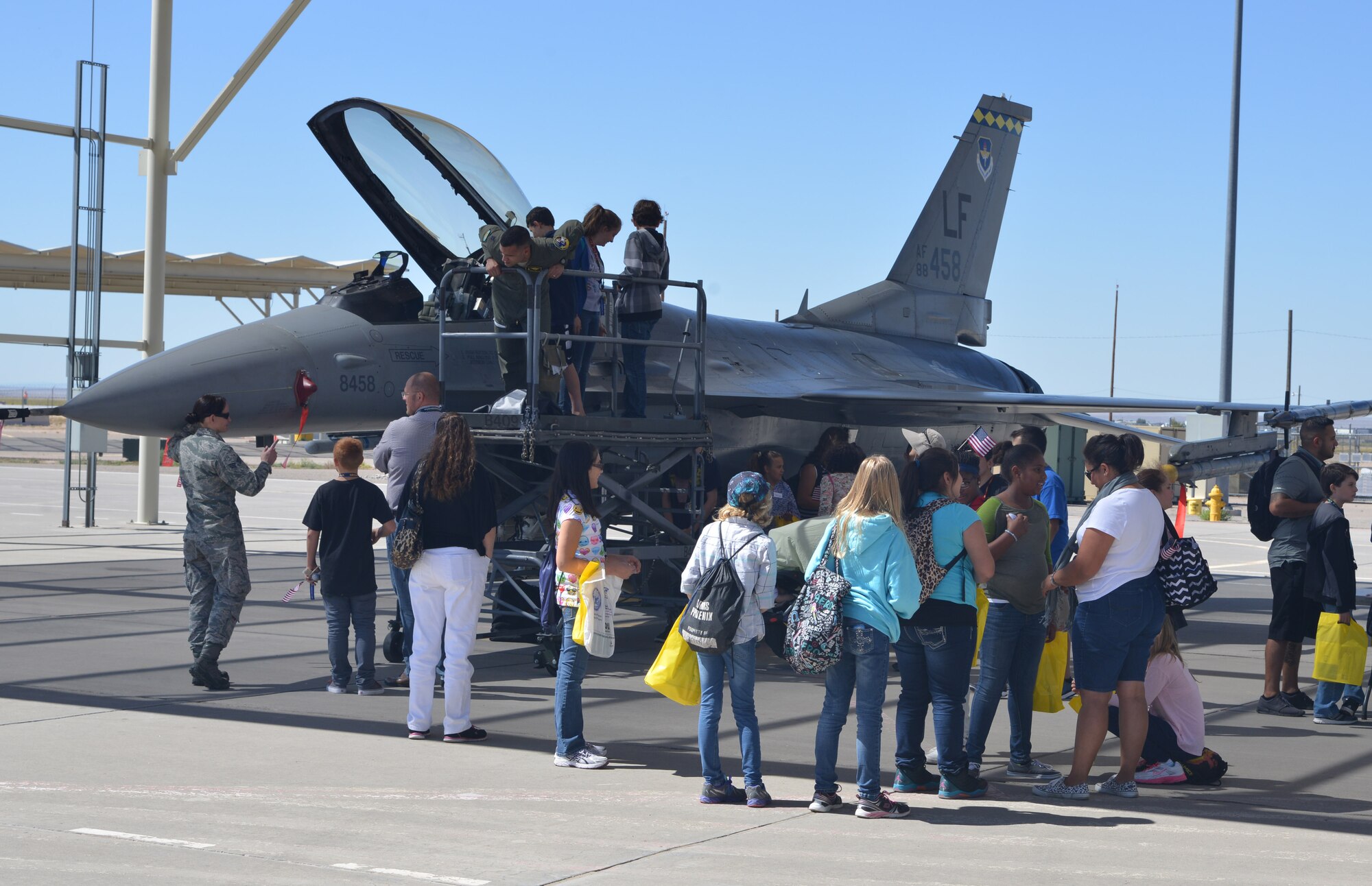 Youth participants of the New Mexico Aviation Aerospace Career Expo at Kirtland are shown an F-16 Fighting Falcon aircraft. The expo educates New Mexico youth with information on pursuing a career in the aviation and aerospace industry. (Photo by Todd Berenger)
