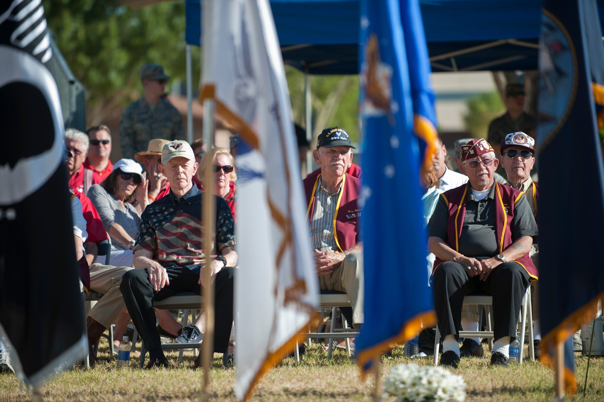 Former prisoners of war and their families watch the events of the Prisoners of War/Missing in Action Recognition Ceremony at Nellis Air Force Base, Nev., Sept. 18, 2015. During the ceremony, Airmen of Nellis AFB honored these men for their commitment and service to the nation during their time spent as POWs. (U.S. Air Force photo by Staff Sgt. Siuta B. Ika)
