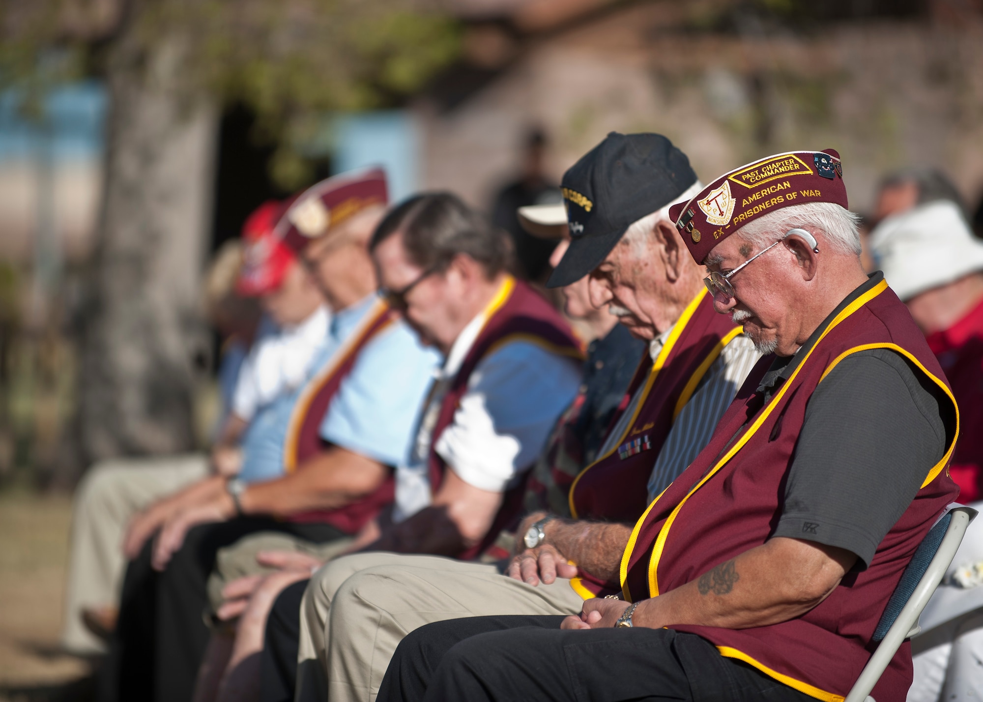Former prisoners of war bow their heads during the Prisoners of War/Missing in Action Recognition Ceremony at Nellis Air Force Base, Nev., Sept. 18, 2015. During the ceremony, Airmen of Nellis AFB honored these men for their commitment and service to the nation during their time spent as POWs. (U.S. Air Force photo by Staff Sgt. Siuta B. Ika)