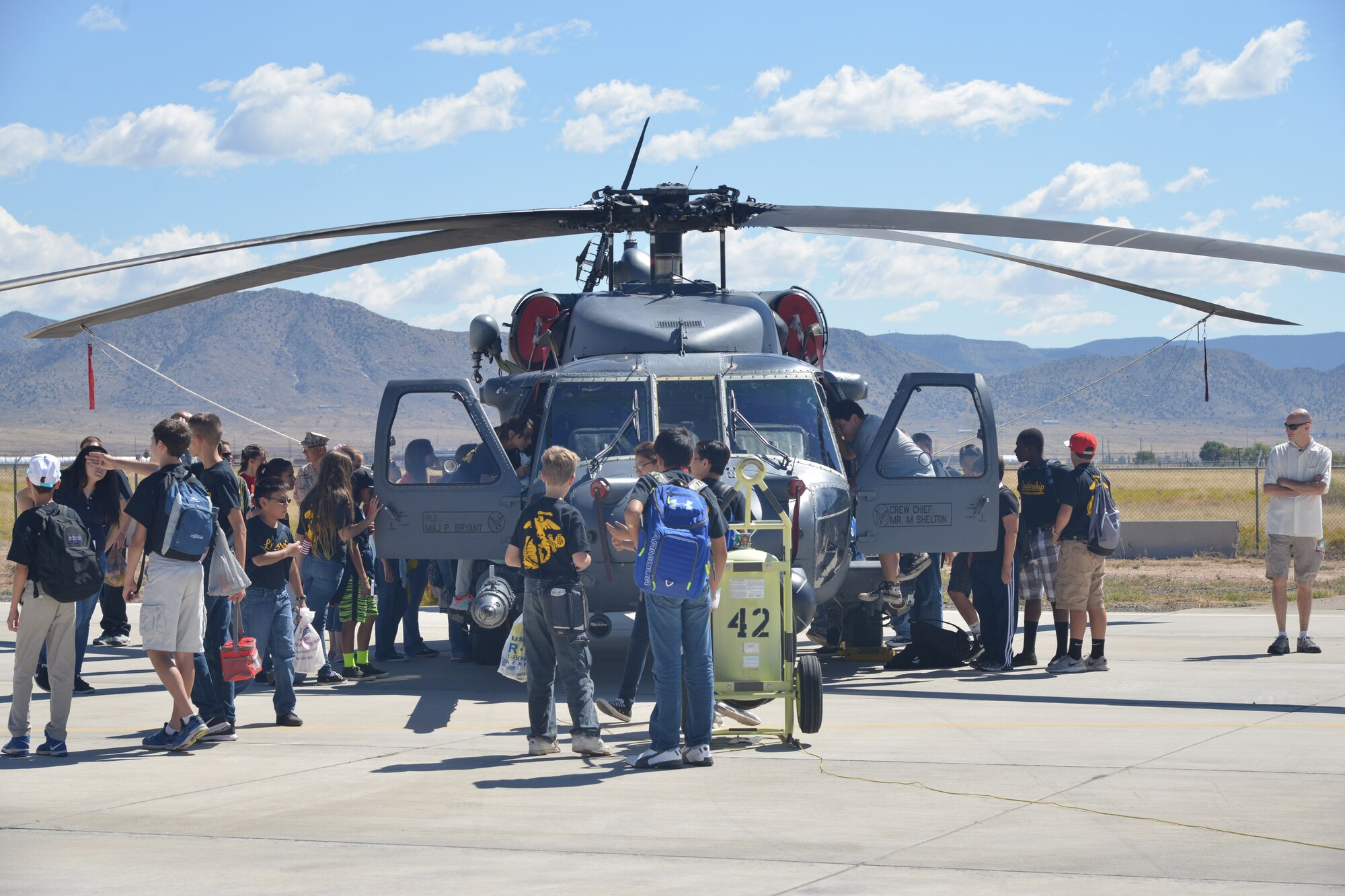 Youth participants of the New Mexico Aviation Aerospace Career Expo at Kirtland congregate around a HH-60 Pave Hawk helicopter. The expo educates New Mexico youth with information on pursuing a career in the aviation and aerospace industry. (Photo by Todd Berenger)
