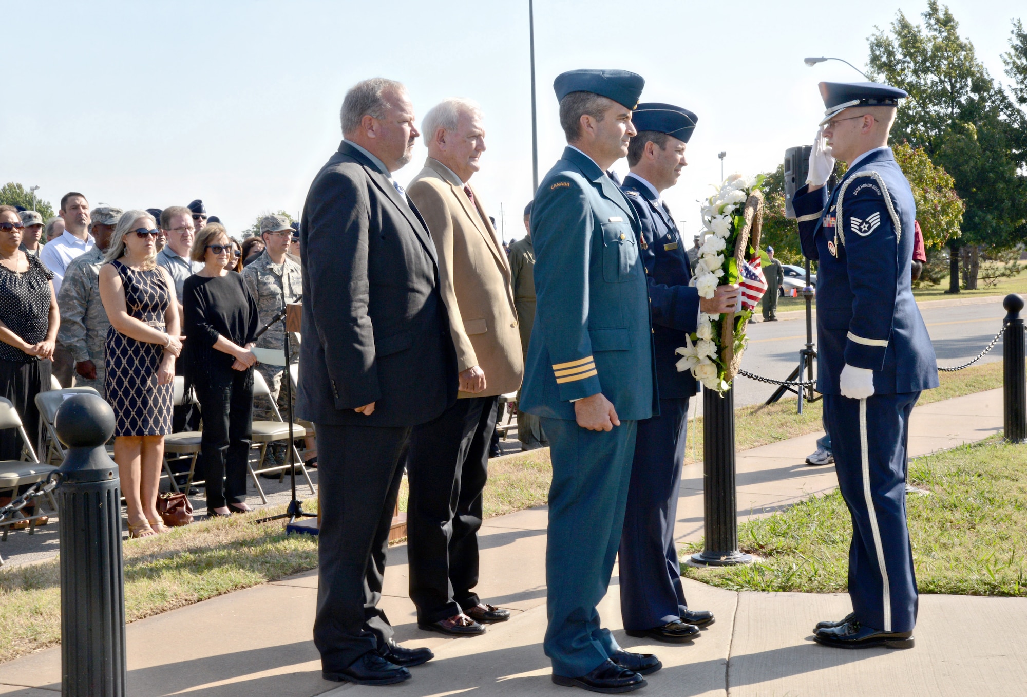 During a Sept. 22 ceremony, Col. David Gaedecke, 552nd Air Control Wing commander, receives a wreath from a member of Tinker’s Honor Guard to place at the foot of the Yukla 27 Memorial. Assisting with the wreath laying are, from left, retired Master Sgt. Ken Lybolt, who was the crew chief for the Yukla; retired Col. Wylie Koiner, former 552nd ACW commander; and Lt. Col. Don “Boc” Saunders, Canadian Detachment commander. The ceremony marked the 20th anniversary of “Yukla two-seven” crashing 42 seconds after takeoff at Elmendorf Air Force Base, Alaska, killing all 24 crew members onboard. (Air Force photo by Kelly White/Released)