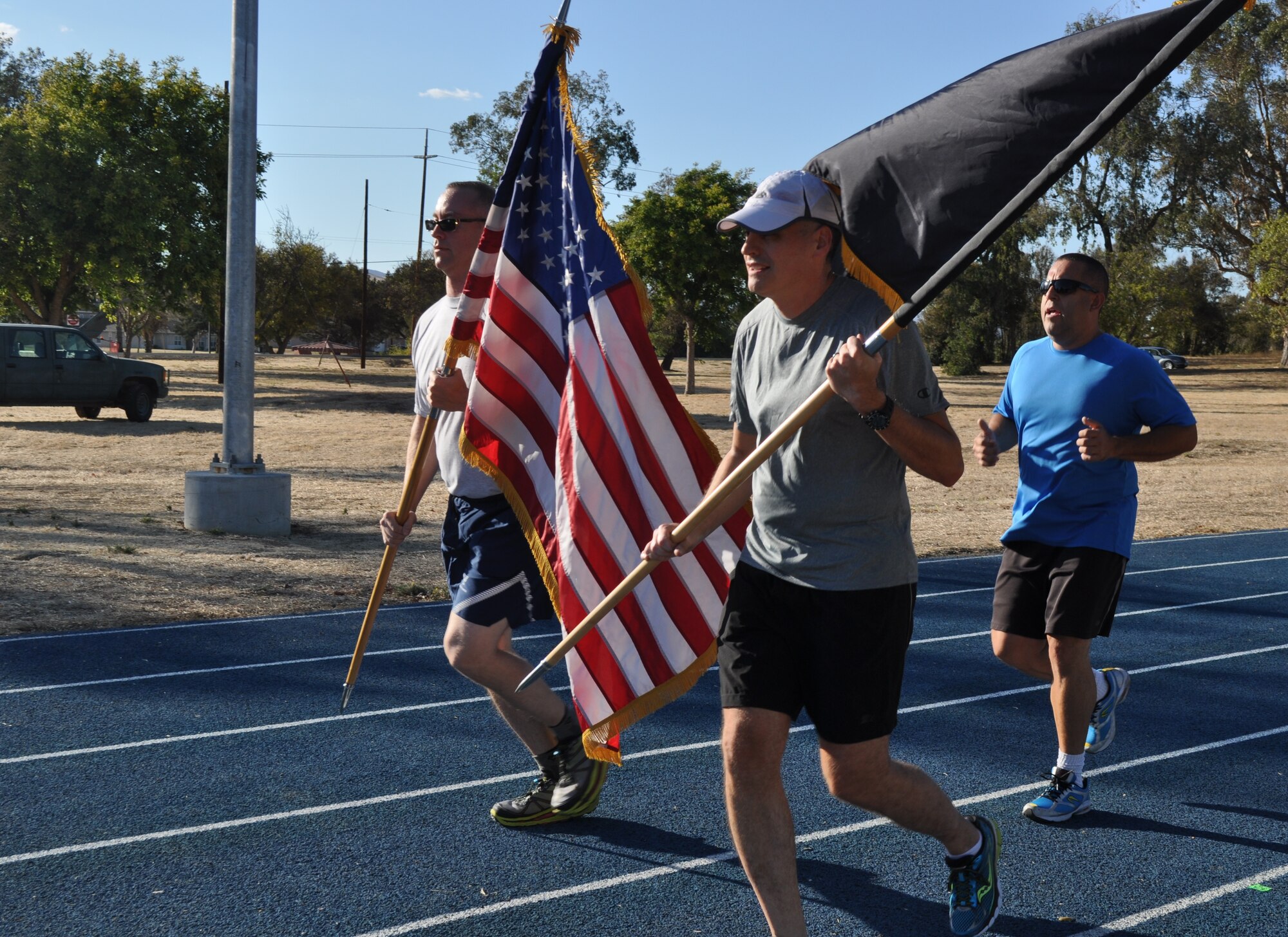TRAVIS AIR FORCE BASE, Calif. -- Travis Team members run with Honor Guard Airmen, and active duty delayed enlistment trainees, during the 24-hour POW/MIA Vigil Run Sept.18 2015. (U.S. Air Force photos/Ellen Hatfield)
