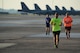 Runners cross the taxiway on the flightline at Barksdale Air Force Base, La., Sept. 19, 2015, during the 2015 Half Marathon and 5K hosted by the 2nd Force Support Squadron. Nearly 300 participants from on and off base, including runners aged 9-69, as well as kids on bikes and others towed in strollers and wagons, joined to race. (U.S. Air Force photo/Tech. Sgt. Thomas Trower)