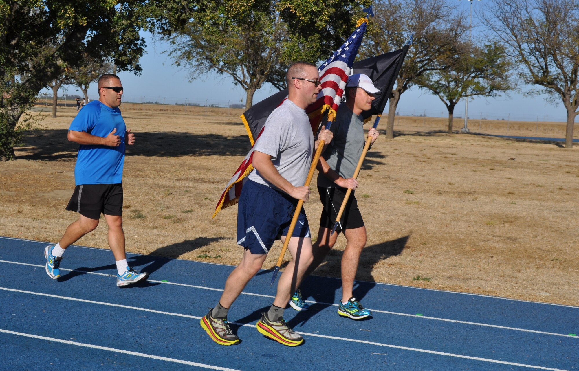 TRAVIS AIR FORCE BASE, Calif. -- Travis Team members run with Honor Guard Airmen, and active duty delayed enlistment trainees, during the 24-hour POW/MIA Vigil Run Sept.18 2015. (U.S. Air Force photos/Ellen Hatfield)
