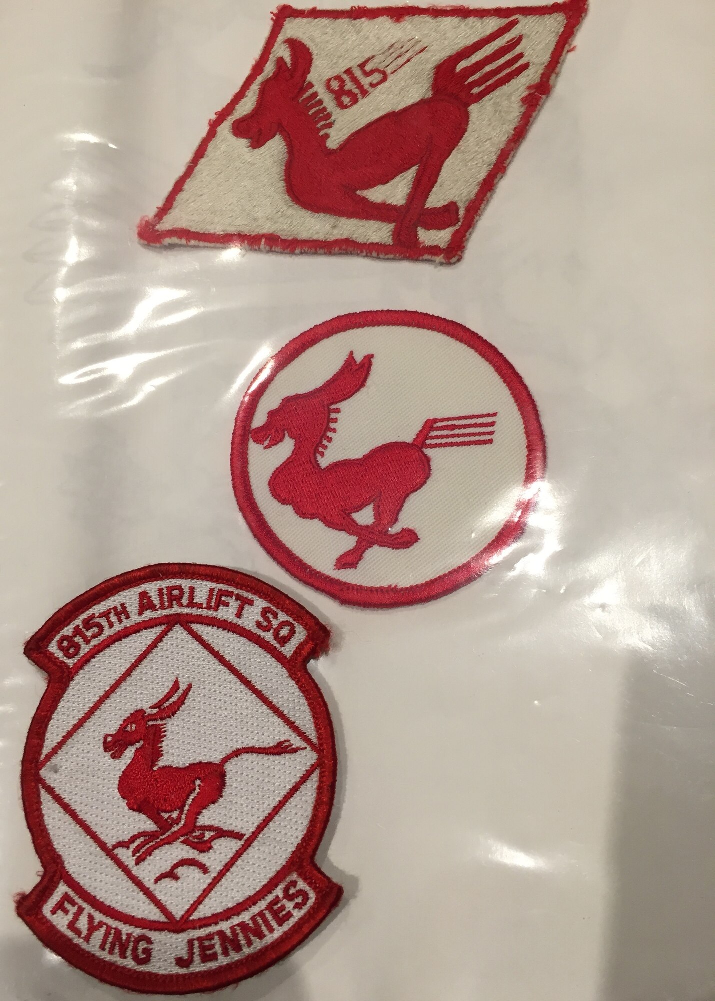 These are three versions of the 815th Airlift Squadron patch as it has evolved since 1944. The current version is on the bottom left. The white square with the cloud base represents the sky, the primary theater of Air Force operations. The Jenny, a pack mule, symbolizes the speed and agility with which the squadron accomplishes its airlift mission. The 815th AS is an Air Force Reserve Command unit assigned to the 403rd Wing at Keesler Air Force Base, Miss. (U.S. Air Force photo)
