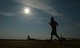 A runner crosses the taxiway on the flightline at Barksdale Air Force Base, La., Sept. 19, 2015, during the 2015 Half Marathon and 5K hosted by the 2nd Force Support Squadron. Nearly 300 participants from on and off base, including runners aged 9-69, as well as kids on bikes and others towed in strollers and wagons, joined to race. (U.S. Air Force photo/Tech. Sgt. Thomas Trower)