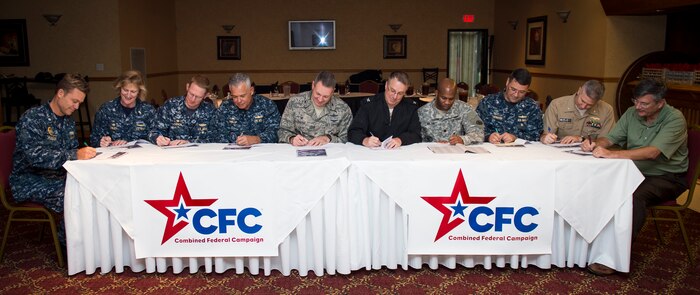 Joint Base Charleston leadership signs their Combined Federal Campaign donation forms Sept. 24, 2015 at the Redbank Club on JB Charleston – Weapons Station, S.C. The CFC’s mission is to promote and support philanthropy through a program that is employee focused, cost-efficient and effective in providing all federal employees the opportunity to improve the quality of life for all. After the CFC signing, Col. Robert Lyman, JB Charleston commander, held a Big 10 luncheon with JB Charleston’s mission partners providing leadership an opportunity to discuss issues or concerns, give mission updates and build team cohesiveness. (U.S. Air Force photo/Airman 1st Class Clayton Cupit)