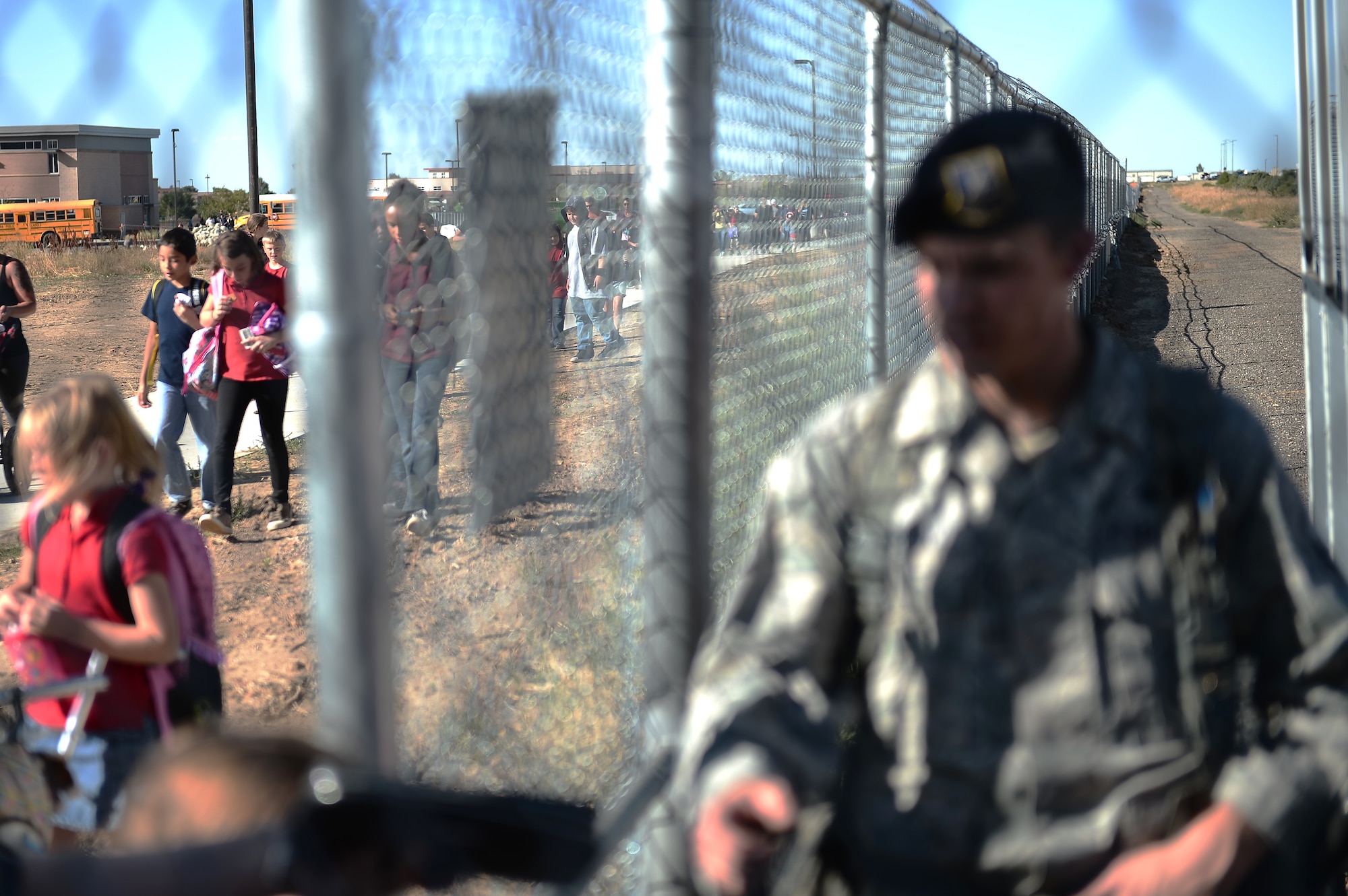 Children line up at the new pedestrian gate on their way home from school Sept. 21, 2015, on Buckley Air Force Base, Colo. The new pedestrian gate benefits families on Buckley AFB by significantly cutting down travel time to get to the P-8 school across the street.