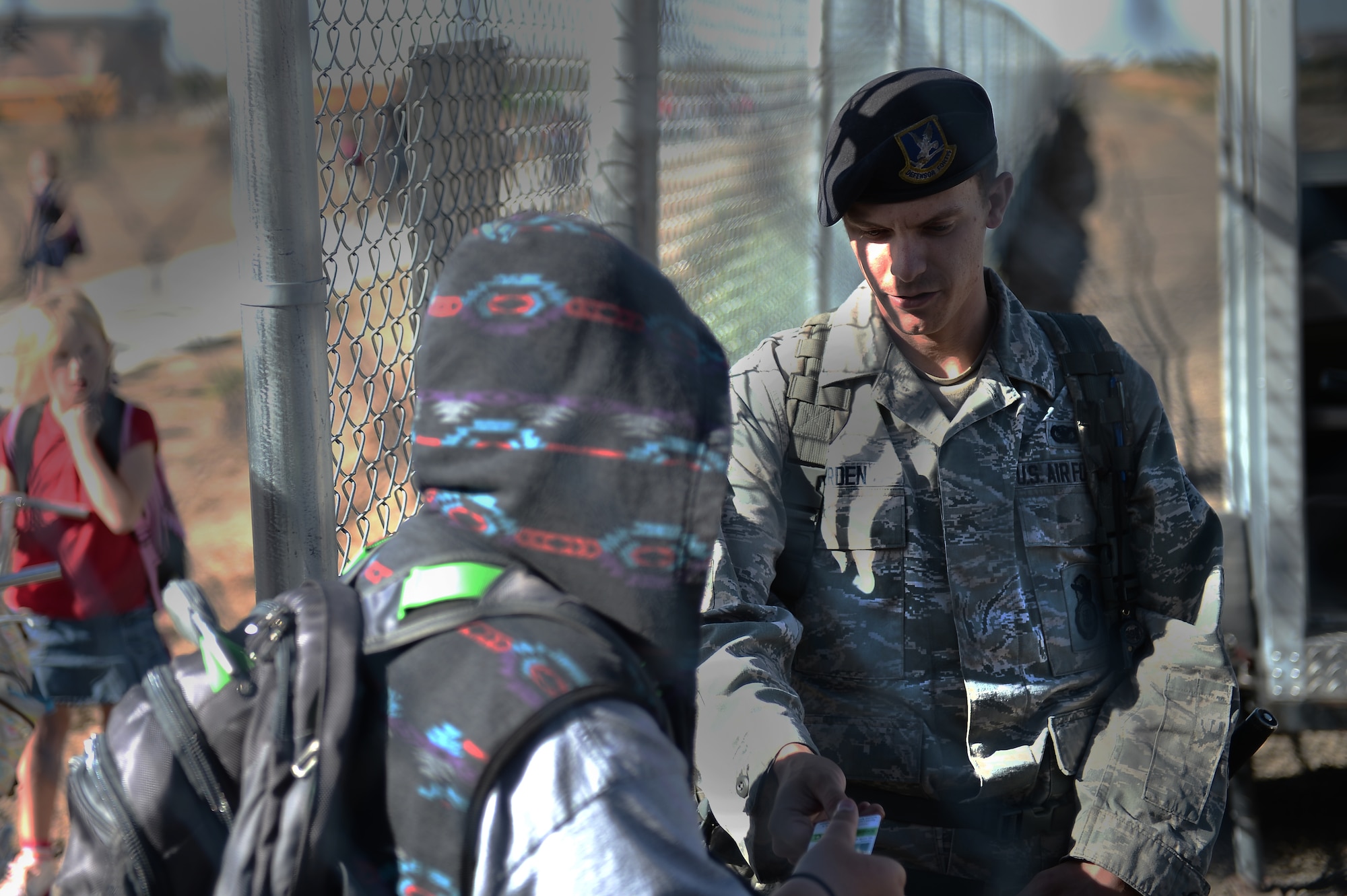 Senior Airman Joshua Durden, 460th Security Forces large vehicle inspection point, checks dependents’ IDs Sept. 21, 2015, at the new pedestrian gate on Buckley Air Force Base, Colo. The new pedestrian gate benefits families on Buckley AFB by significantly cutting down travel time to get to the P-8 school across the street. 